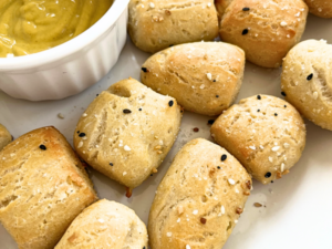 Gluten-free pretzel bites dipped in yellow mustard